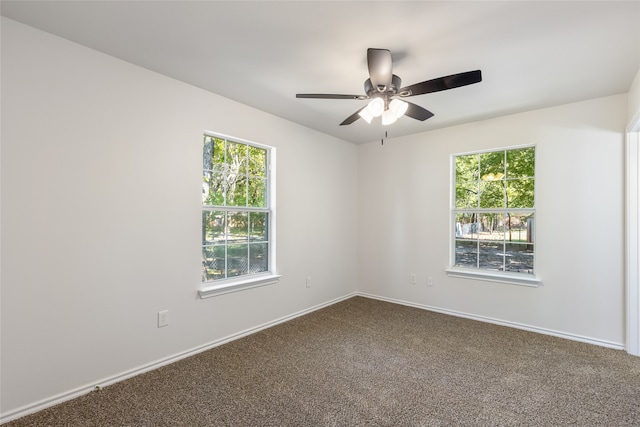 carpeted empty room with ceiling fan and a healthy amount of sunlight