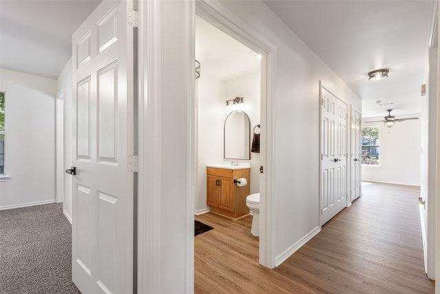 hallway with light hardwood / wood-style flooring