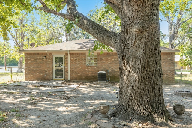 rear view of property featuring central air condition unit