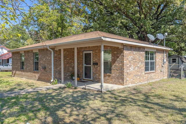 single story home with a patio and a front yard