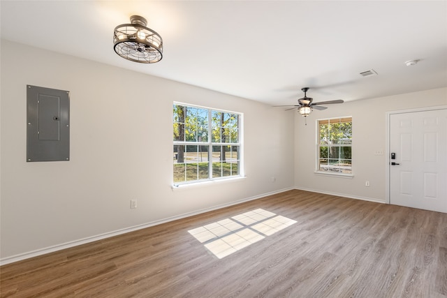 interior space featuring ceiling fan, light hardwood / wood-style floors, and electric panel