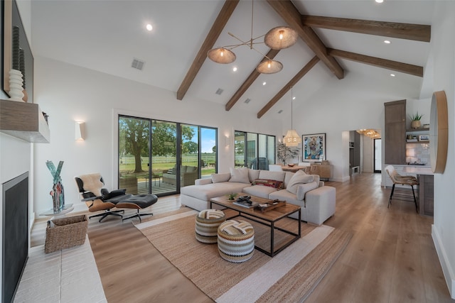 living room with beam ceiling, high vaulted ceiling, light hardwood / wood-style floors, and an inviting chandelier