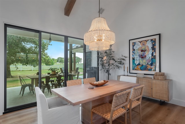 dining area featuring a chandelier, wood-type flooring, high vaulted ceiling, and beam ceiling