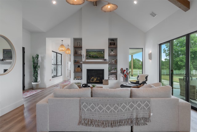 living room featuring wood-type flooring and high vaulted ceiling