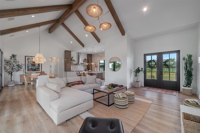 living room featuring beam ceiling, french doors, high vaulted ceiling, and light hardwood / wood-style floors