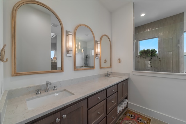 bathroom featuring vanity and a tile shower