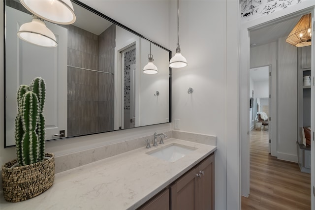 bathroom featuring a shower, vanity, and hardwood / wood-style flooring