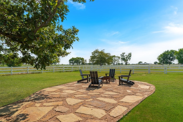 view of patio featuring a rural view and a fire pit