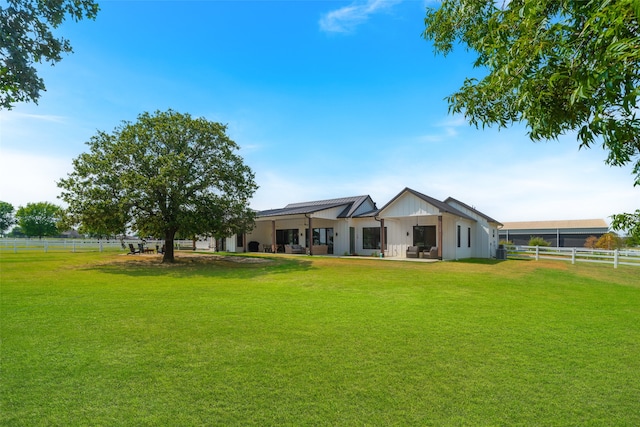 rear view of property with a yard