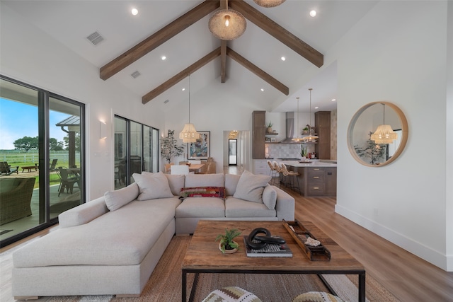 living room featuring beam ceiling, high vaulted ceiling, and light hardwood / wood-style flooring