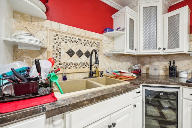 kitchen featuring white cabinetry, tasteful backsplash, sink, and beverage cooler