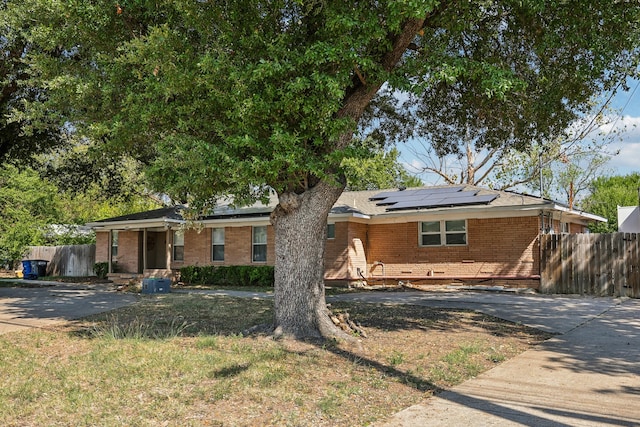 ranch-style home with solar panels