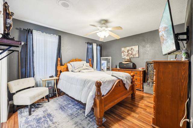 bedroom with hardwood / wood-style flooring and ceiling fan