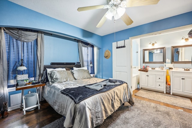 bedroom with sink, dark hardwood / wood-style floors, and ceiling fan