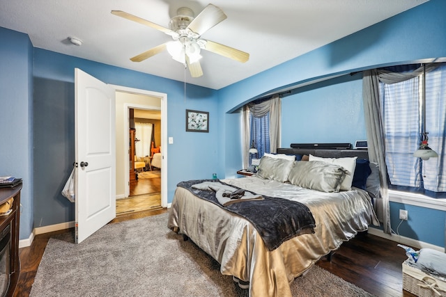 bedroom featuring ceiling fan and dark hardwood / wood-style flooring