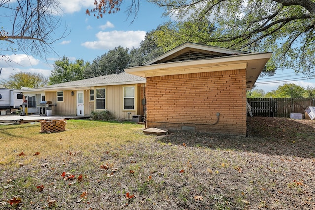 back of property with a patio, central AC, and a yard