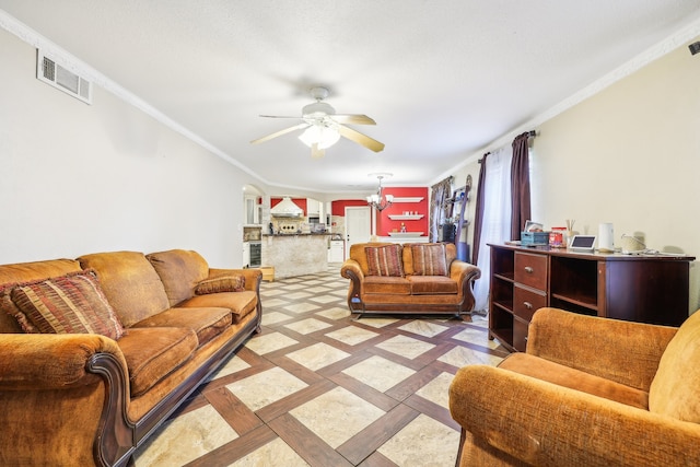 living room with ornamental molding and ceiling fan with notable chandelier