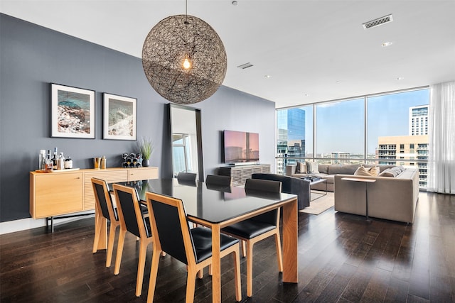 dining space with a wall of windows and dark wood-type flooring