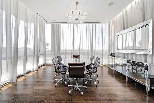 dining area featuring a notable chandelier, plenty of natural light, and dark hardwood / wood-style flooring