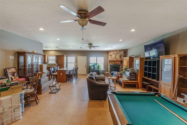 rec room with ceiling fan, light tile patterned flooring, billiards, and a fireplace