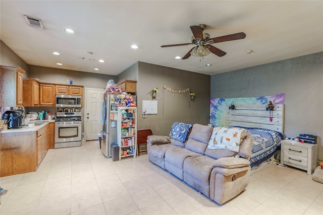 tiled living room with ceiling fan and sink