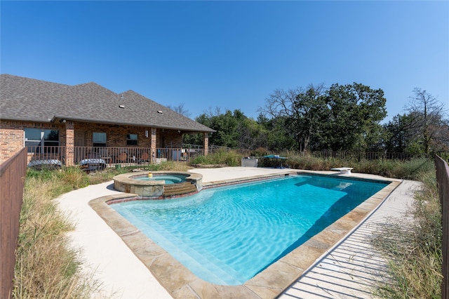 view of swimming pool with an in ground hot tub, a diving board, and a patio