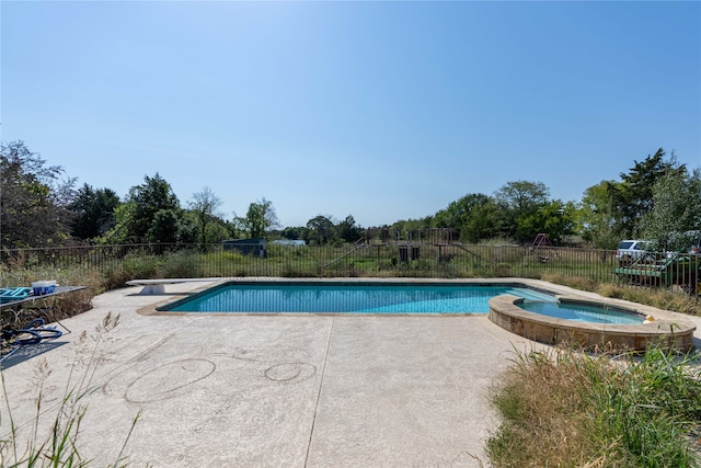 view of pool with a patio, a diving board, and an in ground hot tub