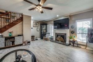 living room featuring ceiling fan, crown molding, and hardwood / wood-style floors