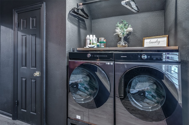 clothes washing area with washer and clothes dryer