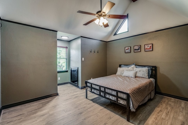 bedroom featuring light hardwood / wood-style flooring, high vaulted ceiling, and ceiling fan