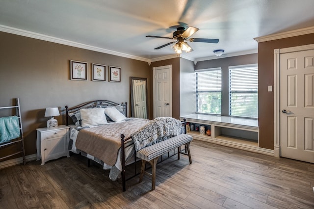 bedroom with ornamental molding, wood-type flooring, and ceiling fan