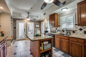 kitchen with a healthy amount of sunlight, sink, tasteful backsplash, and a kitchen island