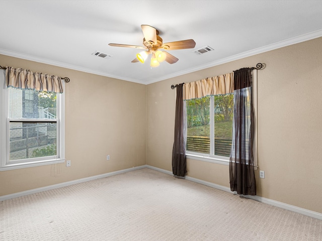 empty room with carpet, ceiling fan, crown molding, and plenty of natural light