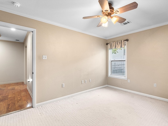 empty room with crown molding, hardwood / wood-style floors, and ceiling fan