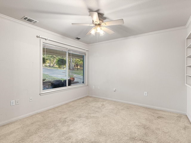 carpeted empty room with crown molding and ceiling fan