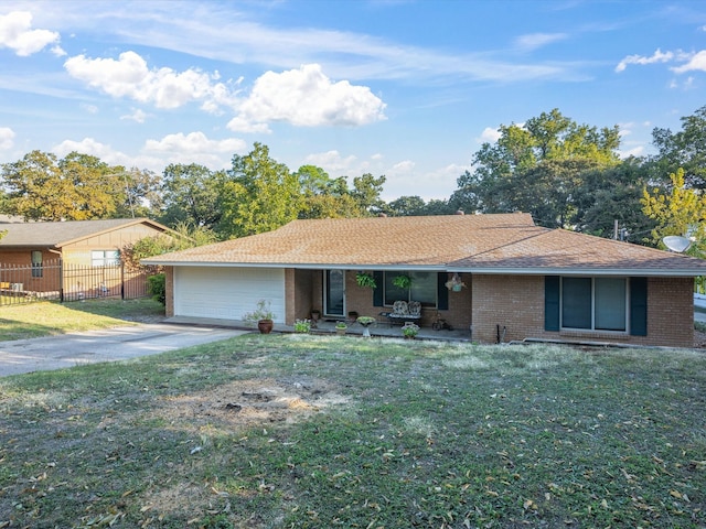 ranch-style house featuring a garage and a front lawn