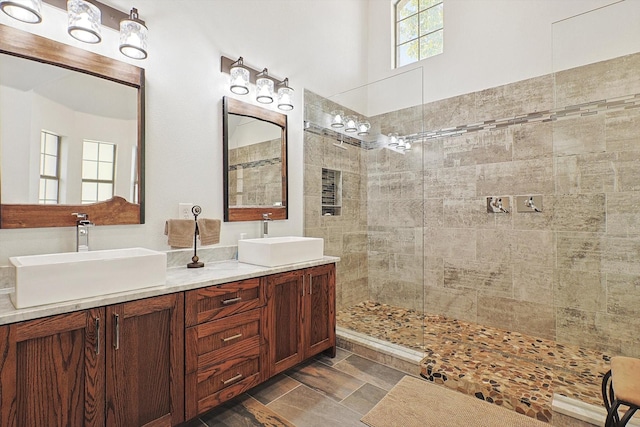 bathroom featuring tiled shower and vanity