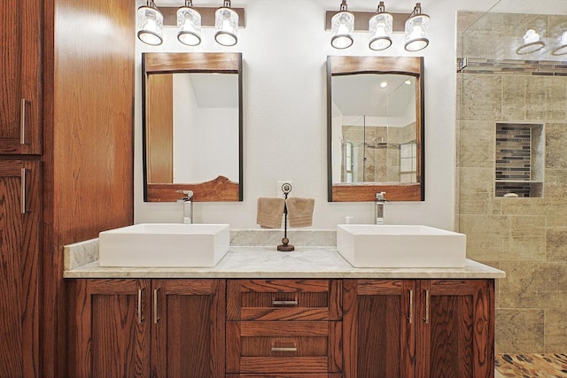 bathroom featuring vanity and a tile shower