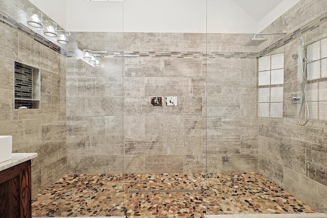 bathroom featuring vanity and a tile shower