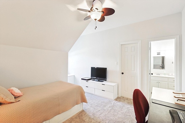 bedroom featuring vaulted ceiling, ceiling fan, light colored carpet, and ensuite bath