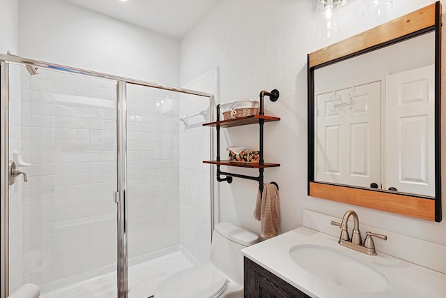 bathroom featuring toilet, walk in shower, and vanity