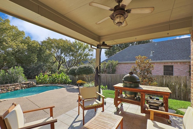 view of patio / terrace with ceiling fan and a fenced in pool