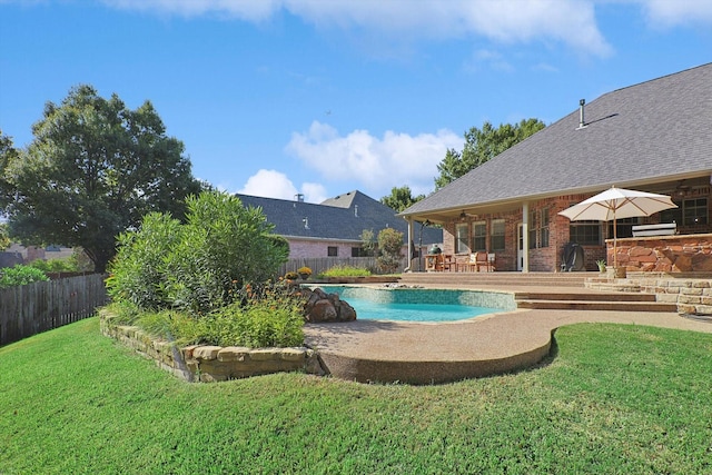 view of pool featuring a lawn