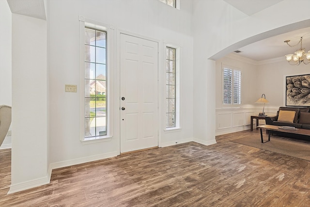 entryway featuring a chandelier, a healthy amount of sunlight, and hardwood / wood-style floors