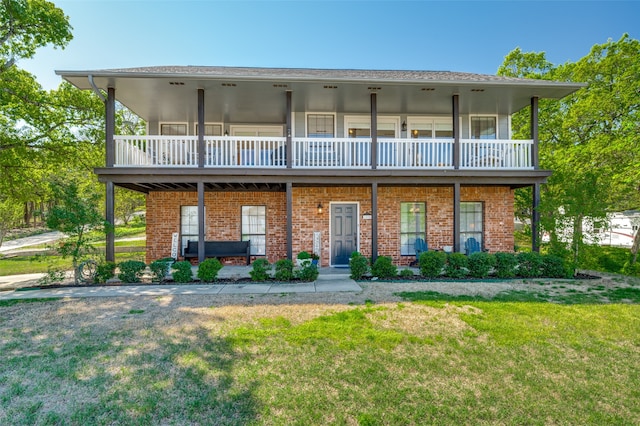 view of front of property with a front yard and a balcony