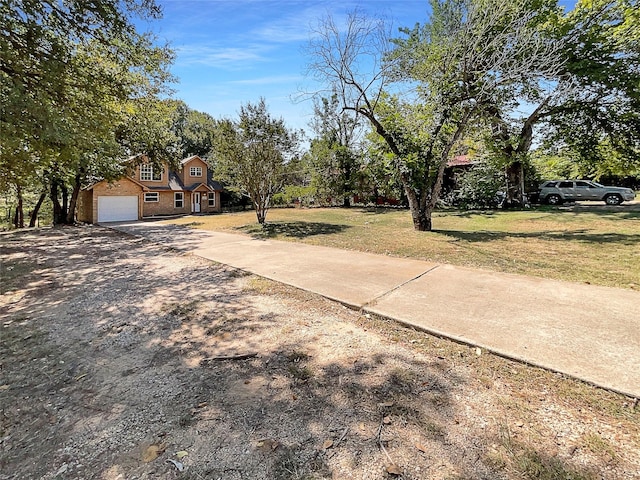 117 Avondale Ave, Azle, TX 76020 - view of yard with a garage and concrete driveway