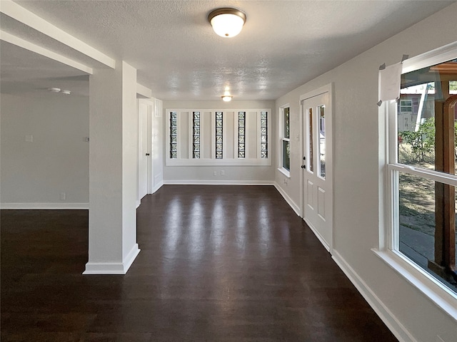 entryway featuring dark hardwood / wood-style flooring and a textured ceiling