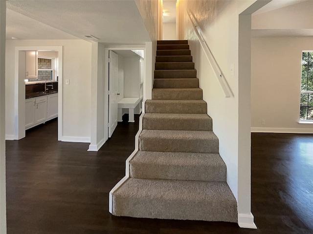 stairway featuring hardwood / wood-style floors