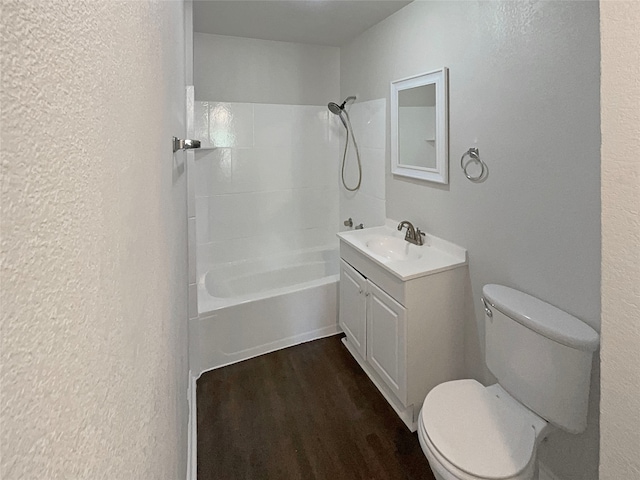 full bathroom featuring  shower combination, vanity, toilet, and hardwood / wood-style flooring