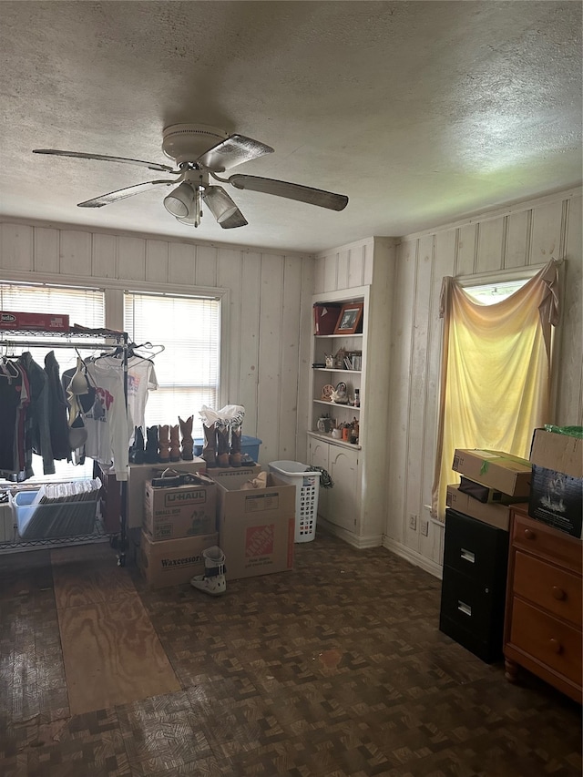 office space with a textured ceiling and ceiling fan